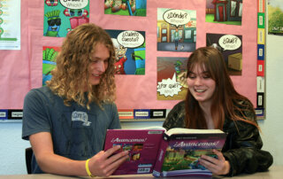 International Baccalaurate students reading a Spanish book.